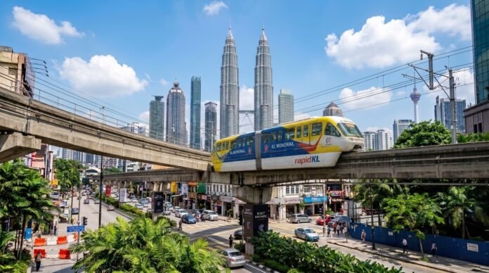 An elevated metro train above a KL street with the skyline behind, for a guide on getting around Kuala Lumpur