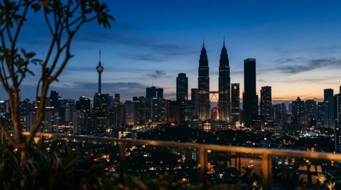 Kuala Lumpur skyline at dusk for the KL Tower vs Petronas Towers comparison
