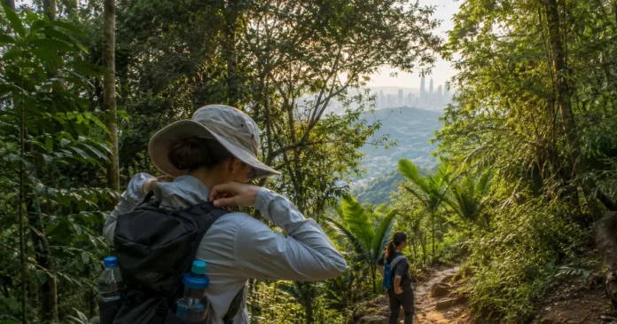 Prepared hikers carrying water on a rainforest trail near Kuala Lumpur shortly after dawn