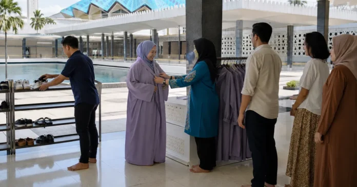 Visitors removing shoes and receiving loan robes at the entrance to a Kuala Lumpur mosque